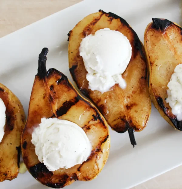 Grill Pears With Icre Cream And Yellow Fruit Syrup